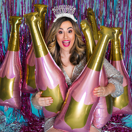 Young woman wearing New Years Eve Party headband saying Champagne Champion